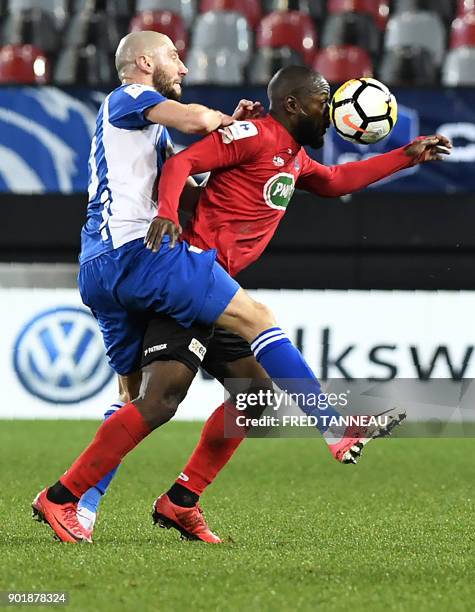 Guingamp's French midfielder Yannis Salibur vies with Niort's midfielder defender Laurent Agouazi during the French Cup football match between...