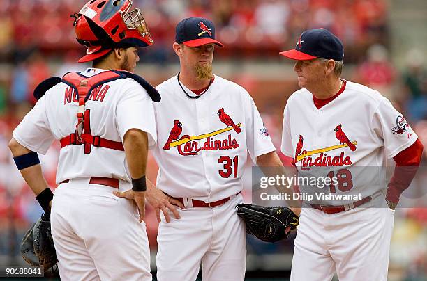 Yadier Molina, Ryan Franklin and pitching coach Dave Duncan all of the St. Louis Cardinals meet on the mound against the Washington Nationals on...