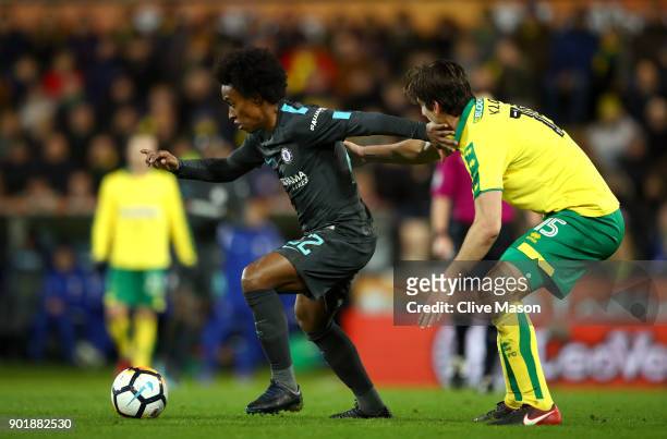 Willian of Chelsea and Timm Klose of Norwich City in action during the The Emirates FA Cup Third Round match between Norwich City and Chelsea at...