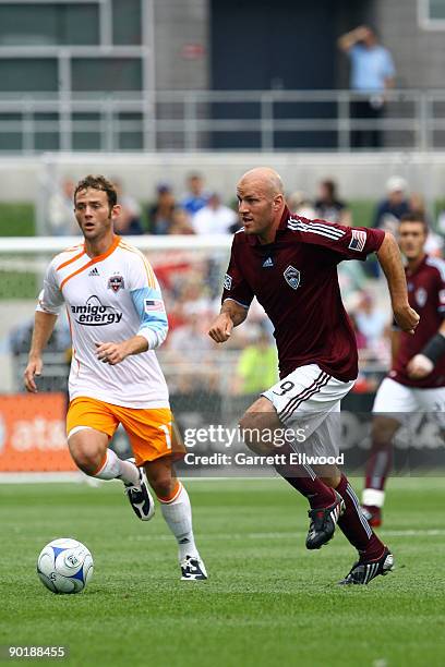 Conor Casey of the Colorado Rapids controls the ball against Brad Davis of the Houston Dynamo on August 30, 2009 at Dicks Sporting Goods Park in...