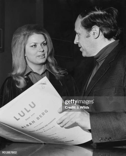 French composer and conductor Pierre Boulez , conductor of the BBC Symphony Orchestra, and American soprano Carole Farley study the score for Alban...