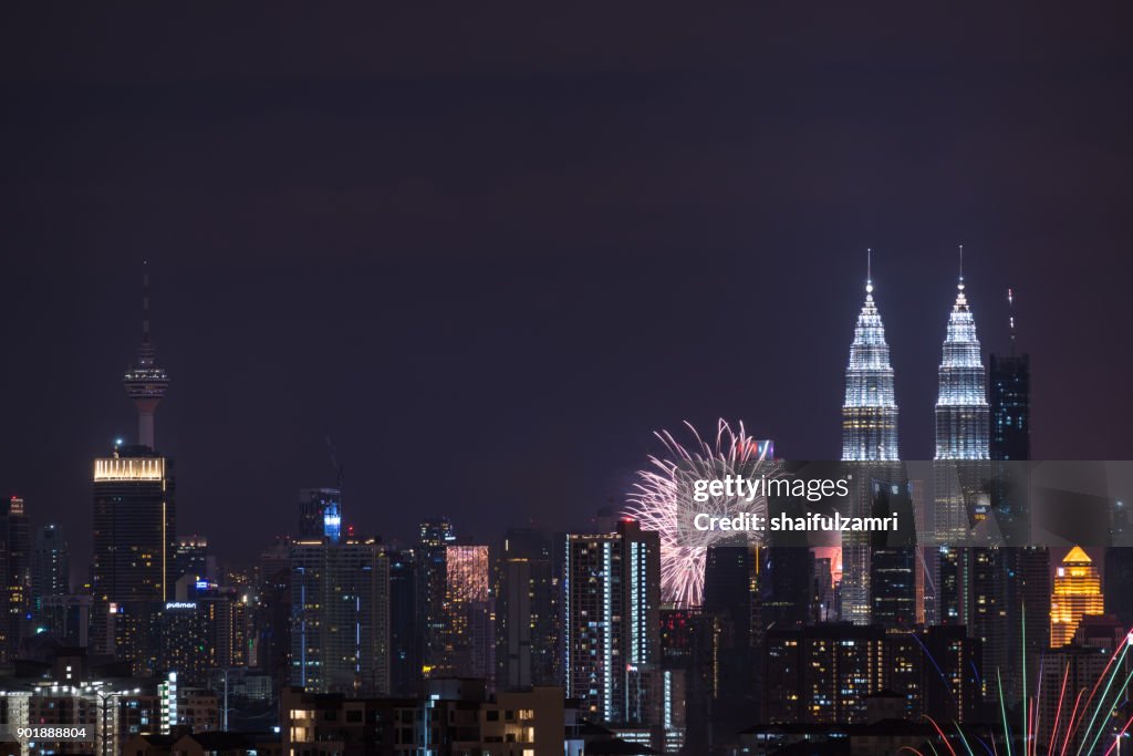 Fireworks explode near Malaysia's landmark Petronas Twin Towers during New Year celebrations in Kuala Lumpur