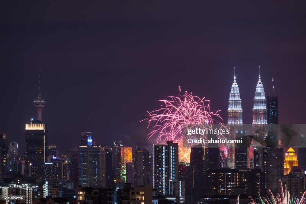Fireworks explode near Malaysia's landmark Petronas Twin Towers during New Year celebrations in Kuala Lumpur