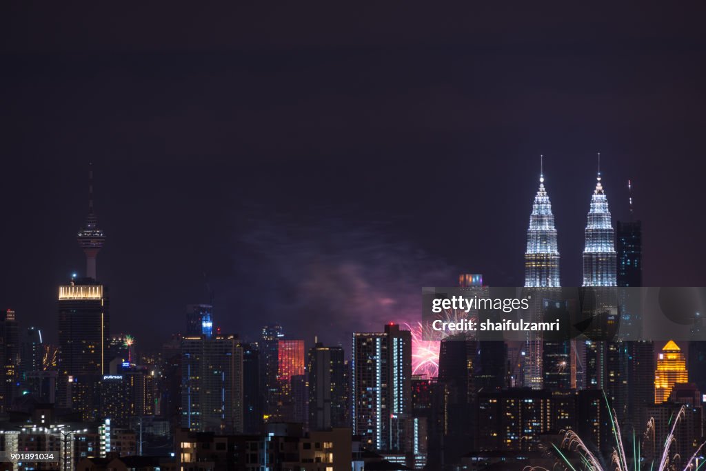 Fireworks explode near Malaysia's landmark Petronas Twin Towers during New Year celebrations in Kuala Lumpur