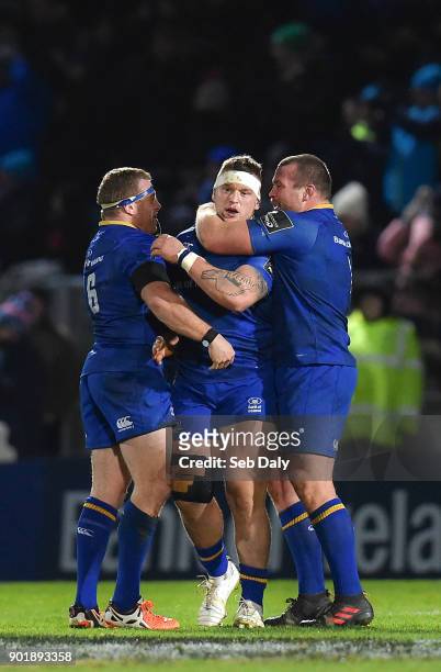 Dublin , Ireland - 6 January 2018; Andrew Porter, centre, of Leinster is congratulated by teammates Sean Cronin, left, and Jack McGrath after playing...