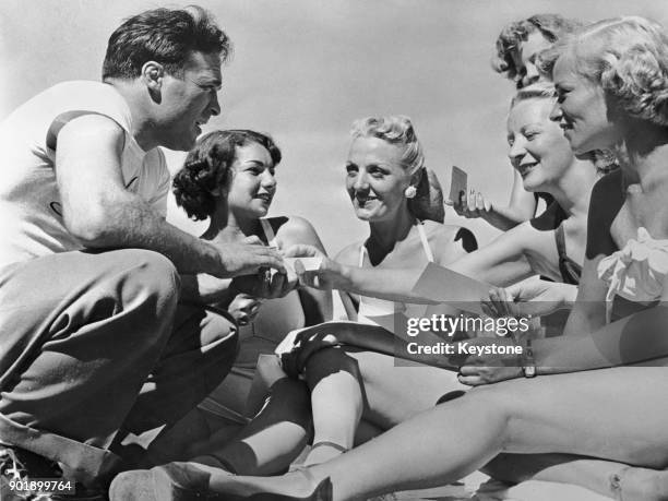 French boxer Marcel Cerdan , the middleweight champion of Europe, with some of the guests at the Hotel Evans in Loch Sheldrake, New York State, where...