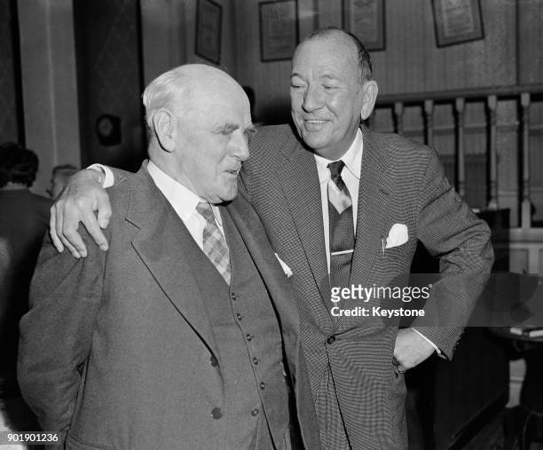 English playwright Noël Coward chats to actor Sir Lewis Casson at the Cambridge Theatre, UK, 29th July 1960. Coward is meeting the cast line-up for...