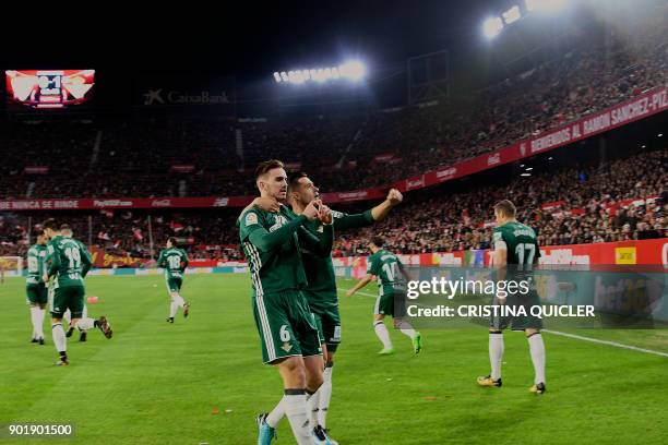 Real Betis' Spanish midfielder Fabian Ruiz celebrates with teammates after scoring a goal during the Spanish league football match between Sevilla...