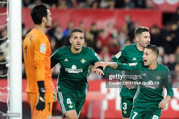 Real Betis' Moroccan defender Zou Feddal celebrates with teammates after scoring a goal during the Spanish league football match between Sevilla and...