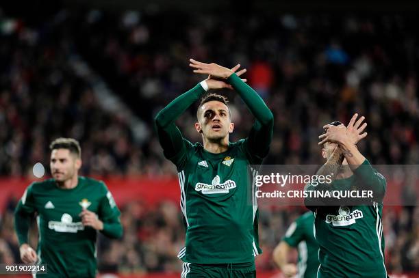 Real Betis' Moroccan defender Zou Feddal celebrates with teammates after scoring a goal during the Spanish league football match between Sevilla and...