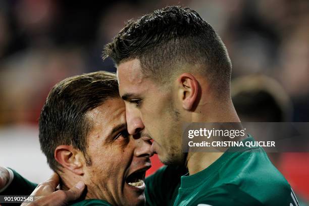 Real Betis' Moroccan defender Zou Feddal celebrates with Real Betis' Spanish midfielder Joaquin after scoring a goal during the Spanish league...
