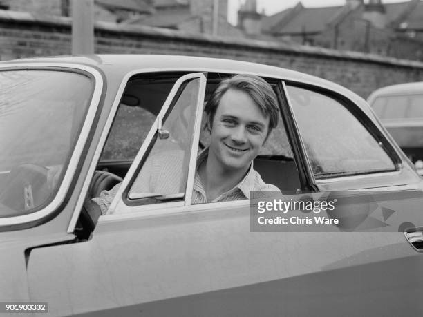 English actor Christopher Cazenove at the wheel of his left-hand drive Alfa Romeo, UK, March 1972.