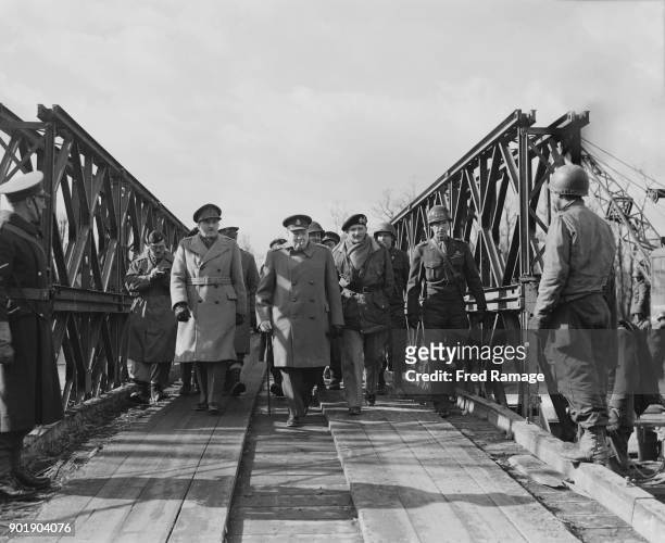 British Prime Minister Winston Churchill walks over the bailey bridge near Jülich in Germany during a visit to the Western Front, World War II, March...