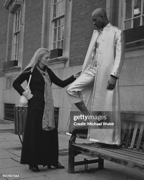 Arabella Churchill , a granddaughter of Sir Winston Churchill, inspects a silver lamé coat and trousers by Tom Gilbey, modelled by Rene Pierre of the...