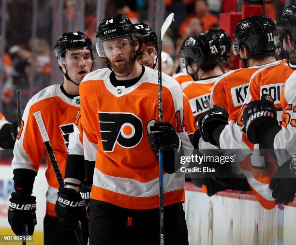Sean Couturier of the Philadelphia Flyers celebrates his empty net goal with teammates on the bench in the third period against the St. Louis Blues...