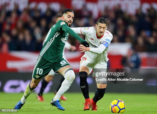 Sergio Escudero of Sevilla FC duels for the ball with Ryad Boudebouz of Real Betis during the La Liga match between Sevilla FC and Real Betis...