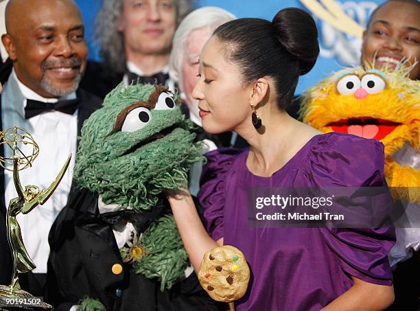 Sandra Oh and the cast of Sesame Street, winners of the Emmy for Lifetime Achievement Award, pose in the press room at the 36th Annual Daytime Emmy...