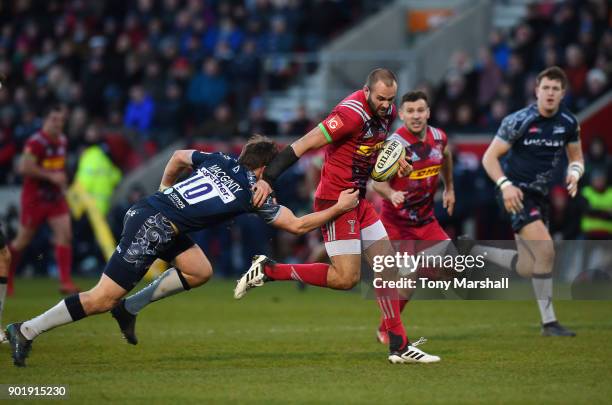 Ross Chisholm of Harlequins runs through a tackle by AJ MacGinty of Sale Sharks to score a try during the Aviva Premiership match between Sale Sharks...