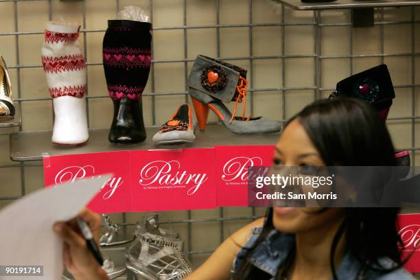 Just released shoes sit on a shelf as television personality Vanessa Simmons signs autographs during a launch for the Smoothie line of her Pastry...