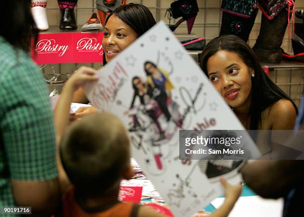 Television personalities Vanessa Simmons and Angela Simmons sign autographs during a launch for the Smoothie line of their Pastry brand shoes at...