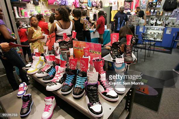 Table of Pastry brand shoes sit in the entrance of Underground Station as television personalities Angela Simmons and Vanessa Simmons sign autographs...