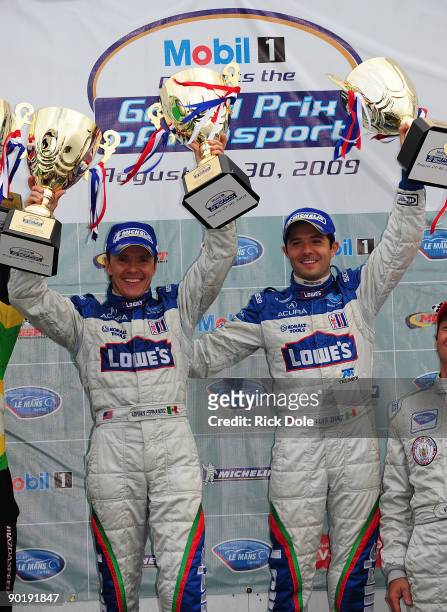 Adrian Fernandez and Luis Diaz, drivers of the Lowe's Fernandez Acura, celebrate after winning the LMP2 class during the American Le Mans Series...