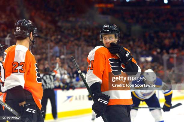 Philadelphia Flyers center Scott Laughton turns to talk to Philadelphia Flyers defenseman Brandon Manning during the NHL game between the St Louis...