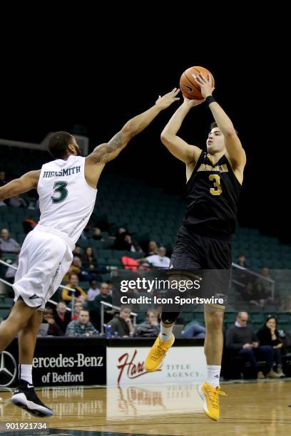 Milwaukee Panthers guard Brock Stull shoots over Cleveland State Vikings Dontel Highsmith during the first half of the men's college basketball game...