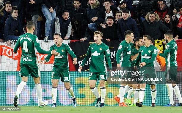 Real Betis' Spanish forward Sergio Leon celebrates with teammates after scoring a goal during the Spanish league football match between Sevilla and...