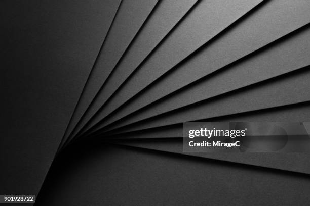 black paper fan shaped stacking - black abstract backgrounds stock pictures, royalty-free photos & images