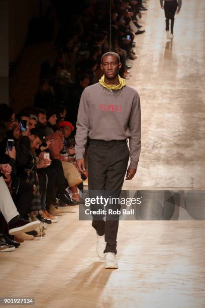 Model walks the runway at the Qasami show during London Fashion Week Men's January 2018 at 100 Sydney Street on January 6, 2018 in London, England.