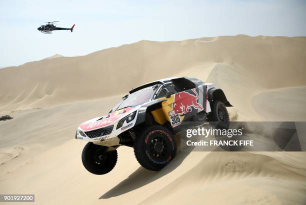 Peugeot's French driver Sebastien Loeb and co-driver Daniel Elena of Monaco compete during the Stage 1 of the 2018 Dakar Rally between Lima and...