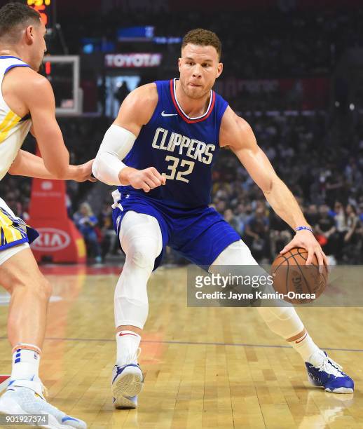 Klay Thompson of the Golden State Warriors guards Blake Griffin of the Los Angeles Clippers as he drives to the basket in the first half of the game...