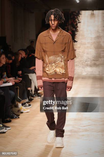 Model walks the runway at the Qasami show during London Fashion Week Men's January 2018 at 100 Sydney Street on January 6, 2018 in London, England.