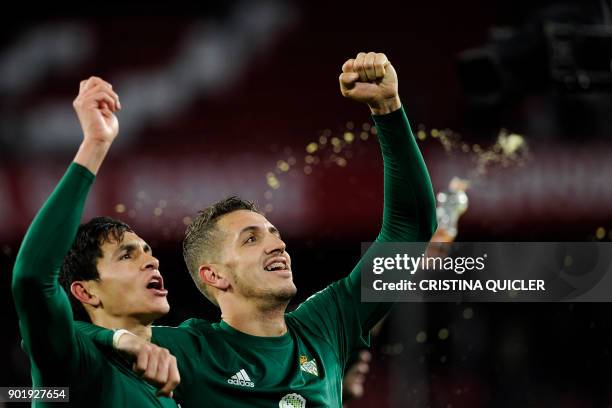 Real Betis' Moroccan defender Zou Feddal celebrates with Real Betis' Algerian defender Aissa Mandi after winning the Spanish league football match...