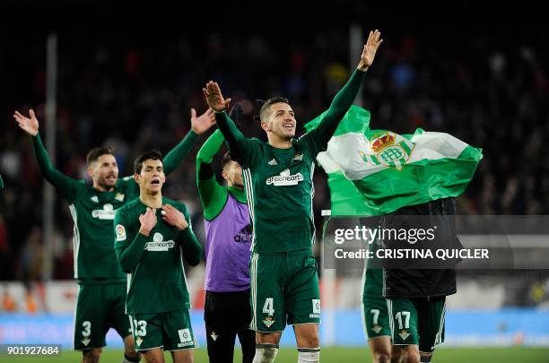 Real Betis' players celebrate at the end of the Spanish league football match between Sevilla and Real Betis at the Sanchez Pizjuan stadium in...