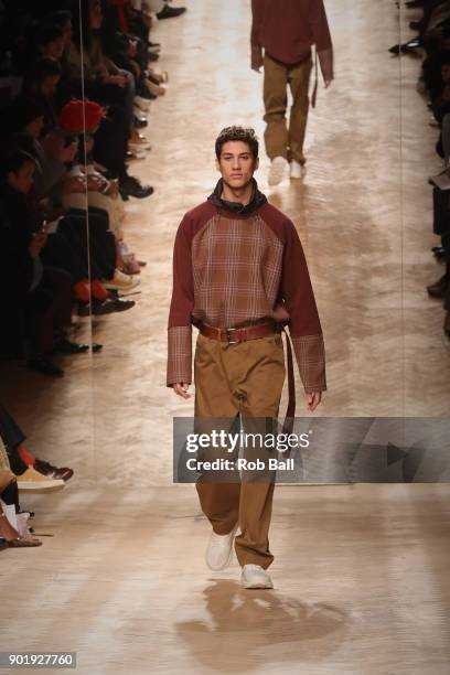 Model walks the runway at the Qasami show during London Fashion Week Men's January 2018 at 100 Sydney Street on January 6, 2018 in London, England.