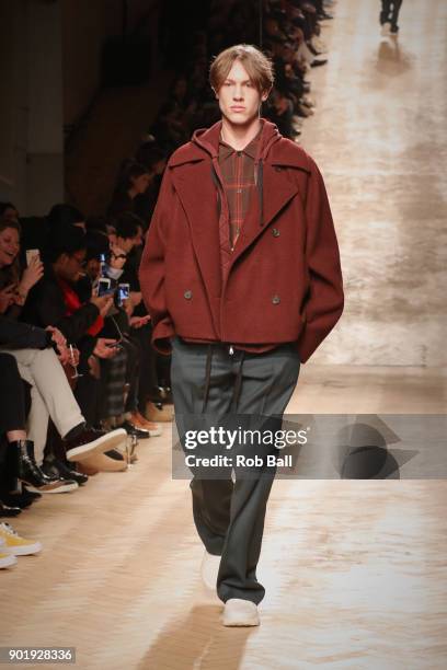 Model walks the runway at the Qasami show during London Fashion Week Men's January 2018 at 100 Sydney Street on January 6, 2018 in London, England.