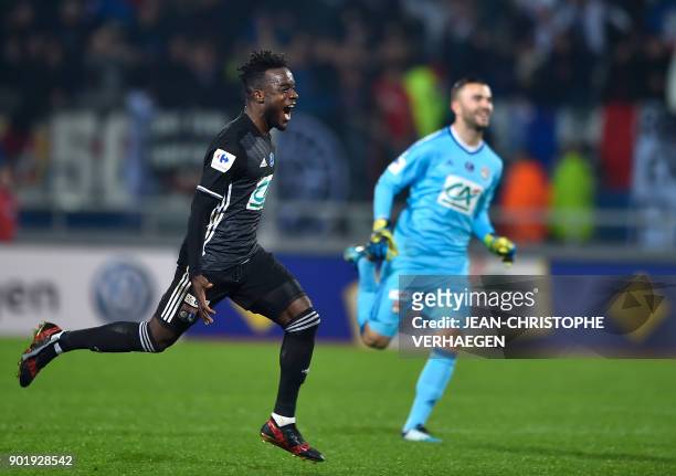 Lyon's French forward Maxwel Cornet and Lyon's French-Portuguese goalkeeper Anthony Lopes celebrate after defeating Nancy during a French Cup round...