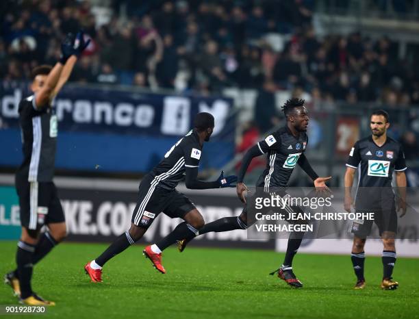 Lyon's players celebrate after defeating Nancy during a French Cup round of 64 football match between Nancy and Lyon on January 6, 2018 at Marcel...