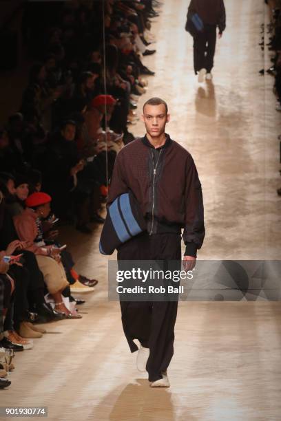 Model walks the runway at the Qasami show during London Fashion Week Men's January 2018 at 100 Sydney Street on January 6, 2018 in London, England.