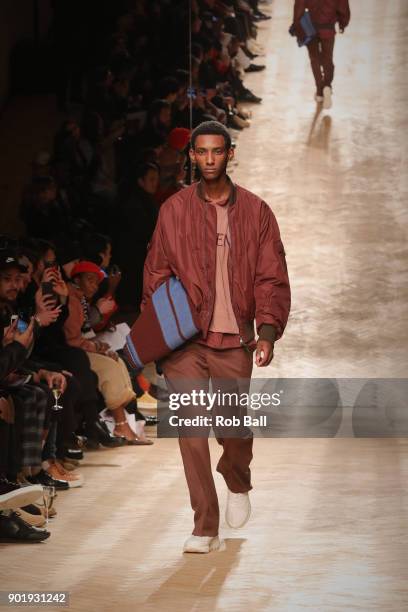 Model walks the runway at the Qasami show during London Fashion Week Men's January 2018 at 100 Sydney Street on January 6, 2018 in London, England.