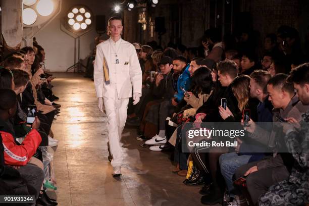 Model walks the runway at the Qasami show during London Fashion Week Men's January 2018 at 100 Sydney Street on January 6, 2018 in London, England.