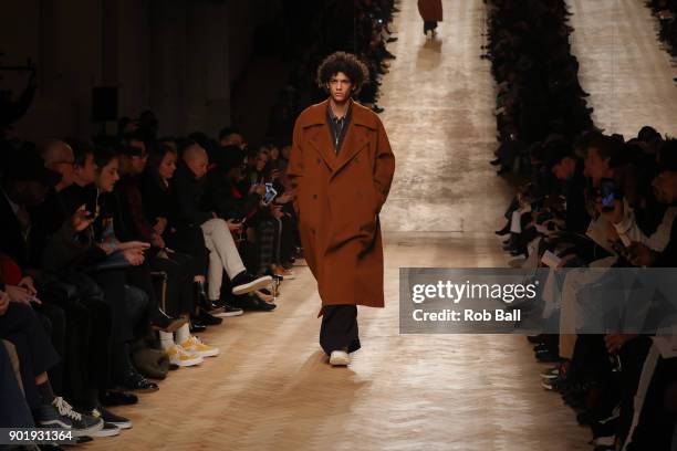 Model walks the runway at the Qasami show during London Fashion Week Men's January 2018 at 100 Sydney Street on January 6, 2018 in London, England.