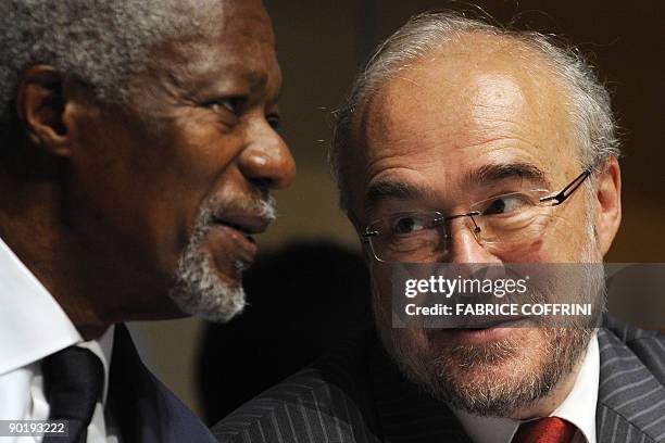 World Meteorological Organization Secretary-General Michel Jarraud speaks with former United Nations Secretary-General Kofi Annan during the opening...
