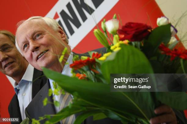 Oskar Lafontaine, co-Chairman of the German left-wing party Die Linke, poses with flowers with leading members of his party a day after regional...