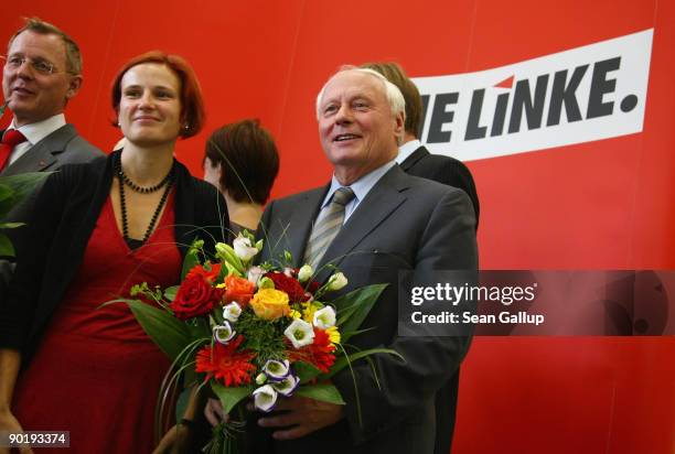 Oskar Lafontaine, co-Chairman of the German left-wing party Die Linke, poses with flowers with leading members of his party a day after regional...