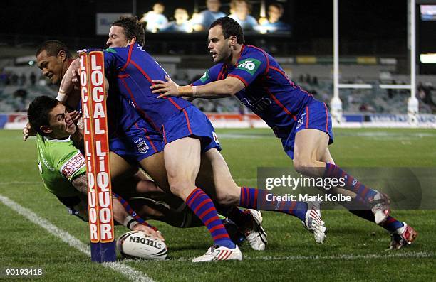 Daniel Vidot of the Raiders dives over to score a try during the round 25 NRL match between the Canberra Raiders and the Newcastle Knights at...