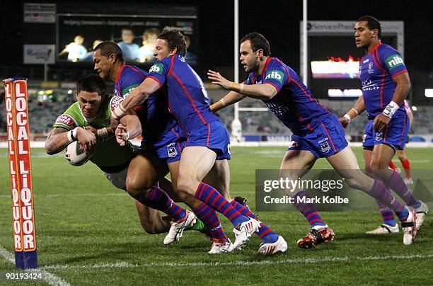 Daniel Vidot of the Raiders dives over to score a try during the round 25 NRL match between the Canberra Raiders and the Newcastle Knights at...