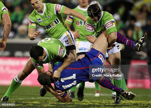 Steve Simpson of the Knights is dumped by the Raiders defence during the round 25 NRL match between the Canberra Raiders and the Newcastle Knights at...